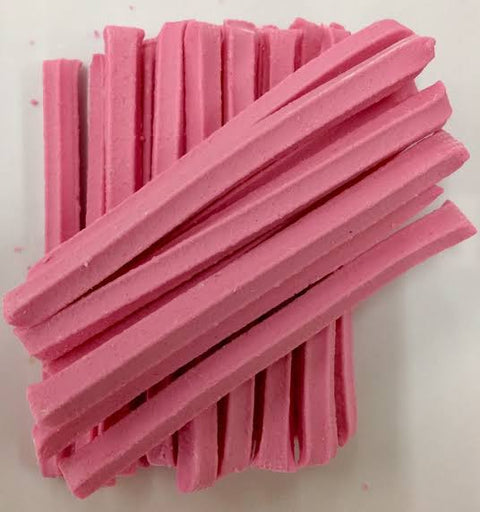 A pile of pink musk sticks candy, with a hard candy coating.